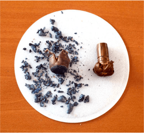 Comparison of bullets recovered after being fired into rain barrel. On left is a jacketed lead bullet, on the right is a solid copper bullet.